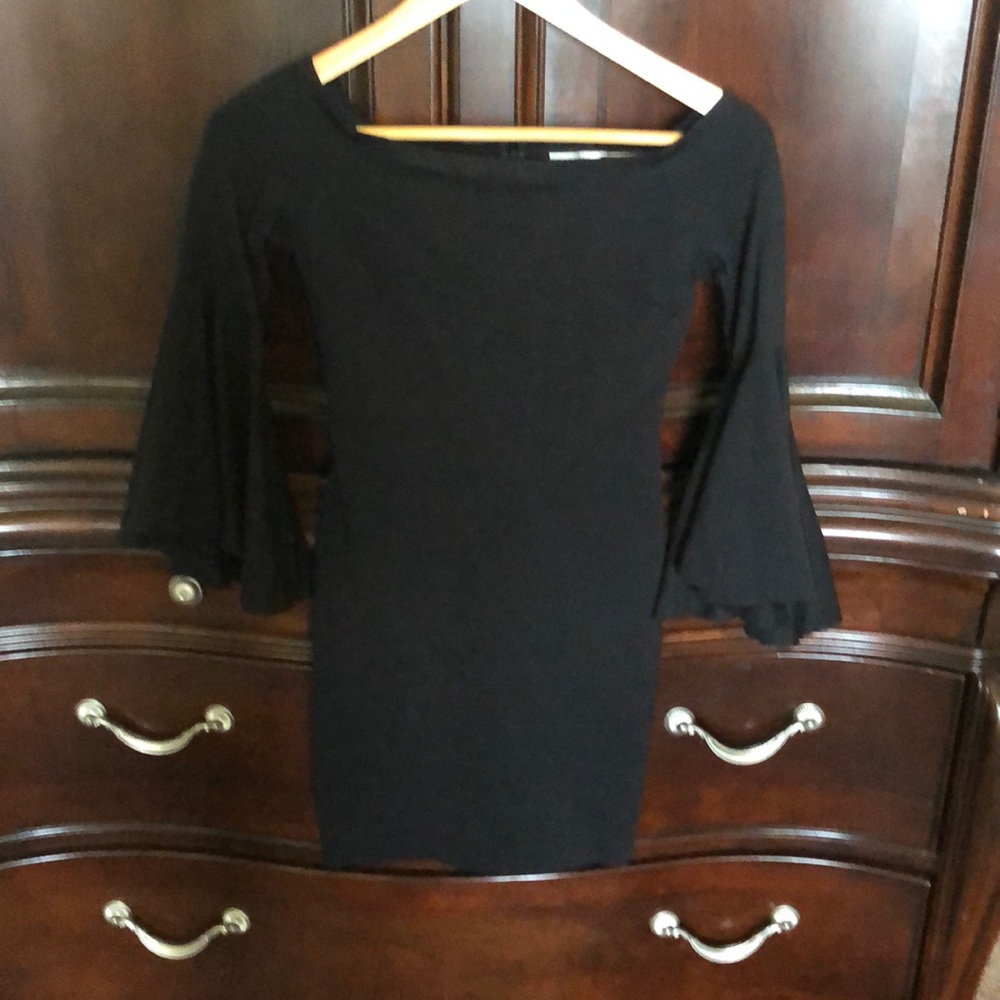Off the shoulder black dress with bell sleeves.